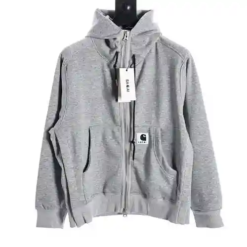 Sacai x Carhartt WIP FW23 Sudadera de patchwork con capucha y abertura con cremallera y logo de Carh