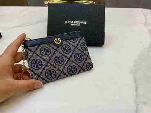 La bolsa para llaves exclusiva para mujer está hecha de material de lona importado, con una bolsa de